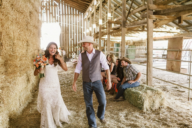 bride and groom dancing as they leave their barn ceremony by heather elizabeth photography