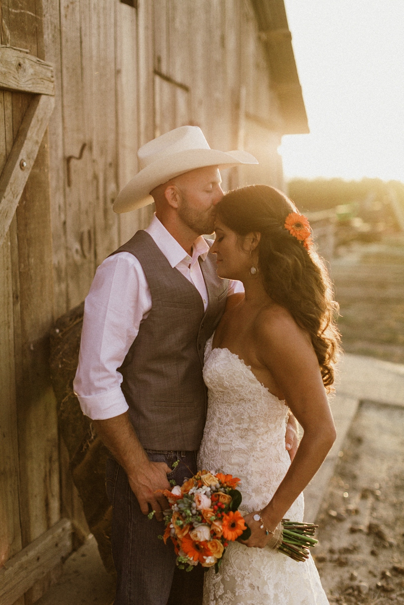 Romantic sunset wedding photo at a couple's barn farmhouse wedding by heather elizabeth photography