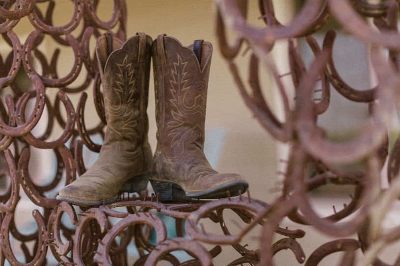 cowboy boots for a bride's wedding shoes at her farmhouse wedding by heather elizabeth photography