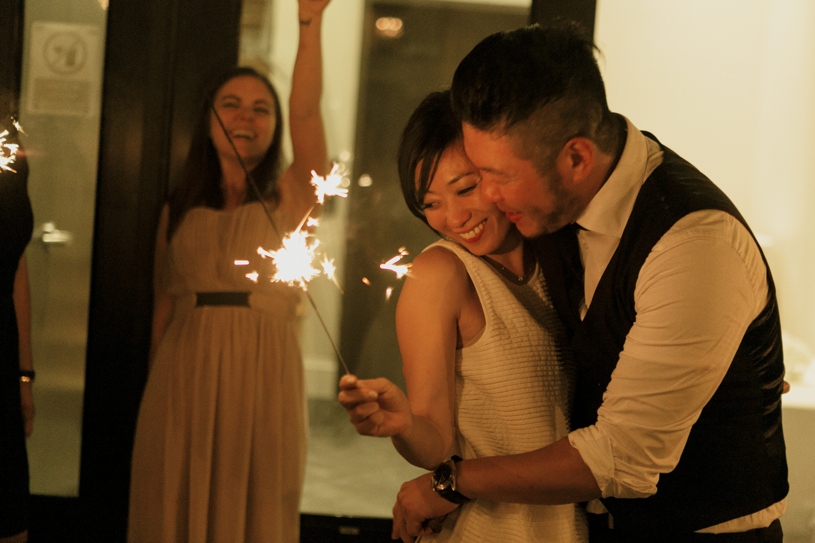 lowlight photography of a wedding sparkler exit in front of firehouse 8 in san francisco by heather elizabeth photography