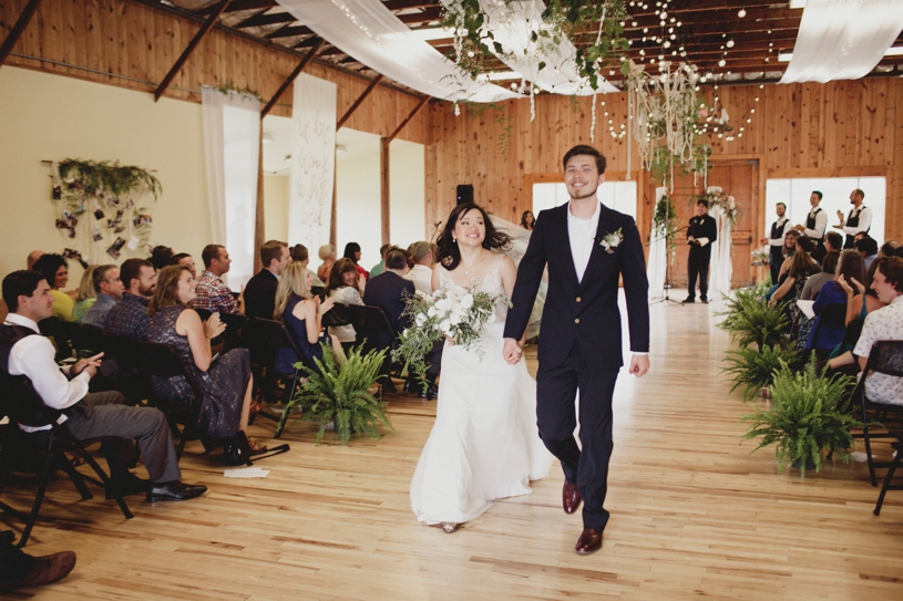 bride and groom leaving their wedding ceremony at the Williams Barn by Heather Elizabeth Photography