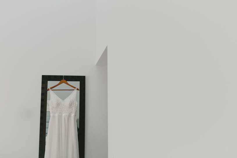 Wedding gown hanging up at the Lakehouse Hotel and Resort in San Marcos California by Heather Elizabeth Photography