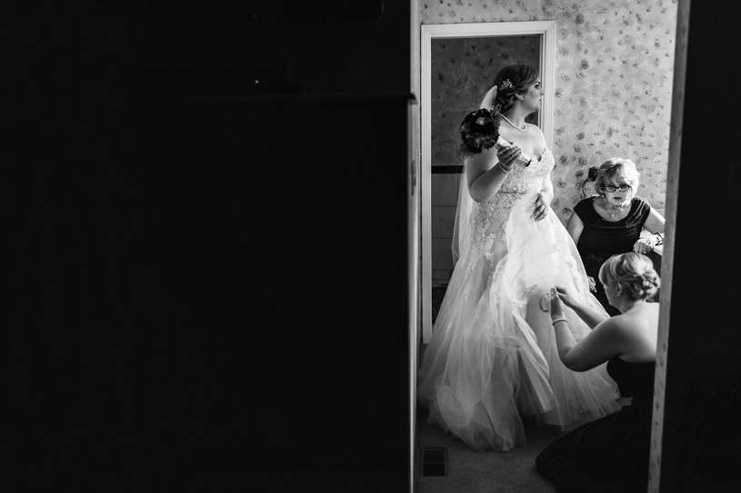 A bride in a Sophia Tolli dress preparing for her wedding in the Bay Area, California by Heather Elizabeth Photography